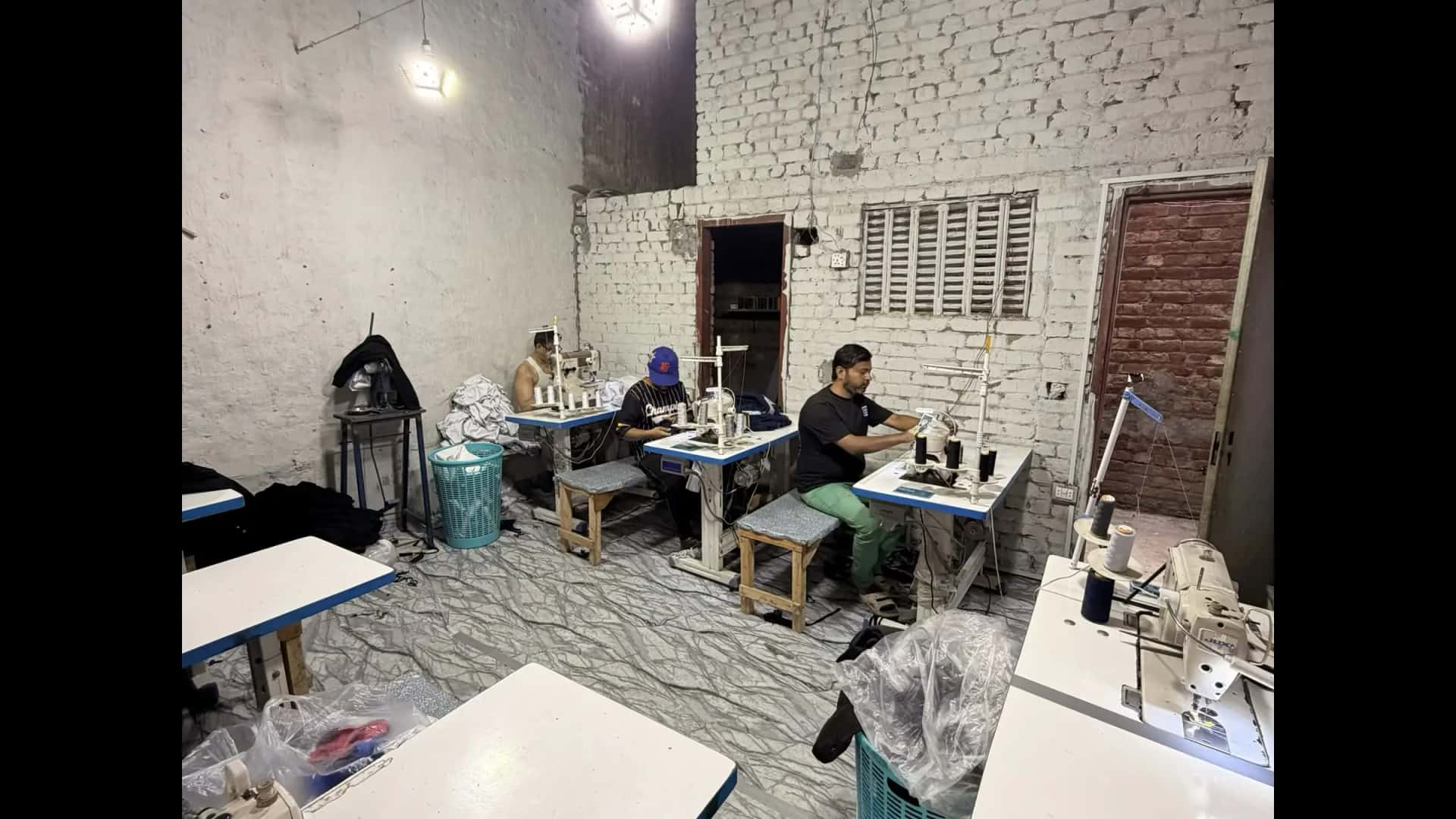 Sewing floor with operators at industrial machines — Mughal Apparel Daska Sialkot