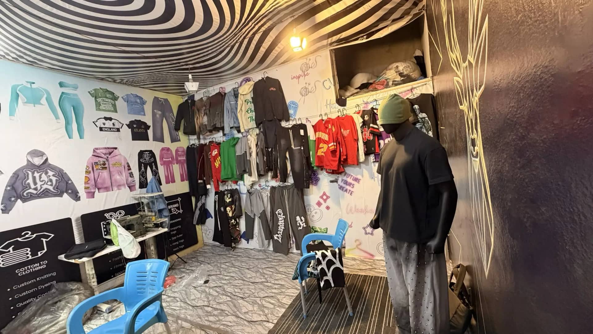 Hoodies and jerseys on display with mannequin — Mughal Apparel sample room